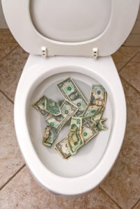 money in a white toilet