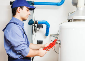 plumber at work on hot water heater